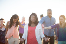 group in prayer outdoors 