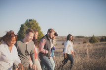 group of people walking outdoors in a field 