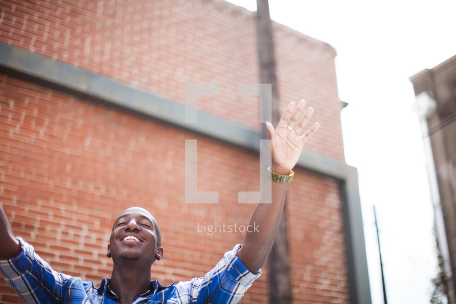 a man with hands raised in worship to God 