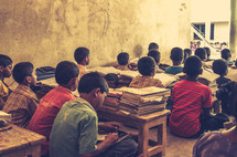 Children in an orphanage in India are studying. 