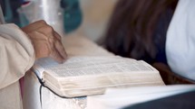 person with a Bible during a worship service 