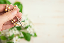 Rosary and branch with white blossoms