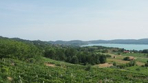 Panning view of Viverone Lake seen from the surrounding hills in Piedmont, Italy