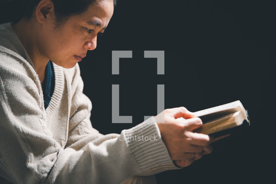 Asian woman holding a Bible