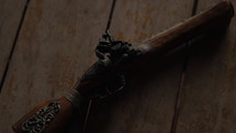 Pirate handgun on table of ship