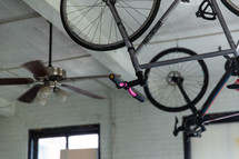 bikes hanging from a ceiling in an apartment 