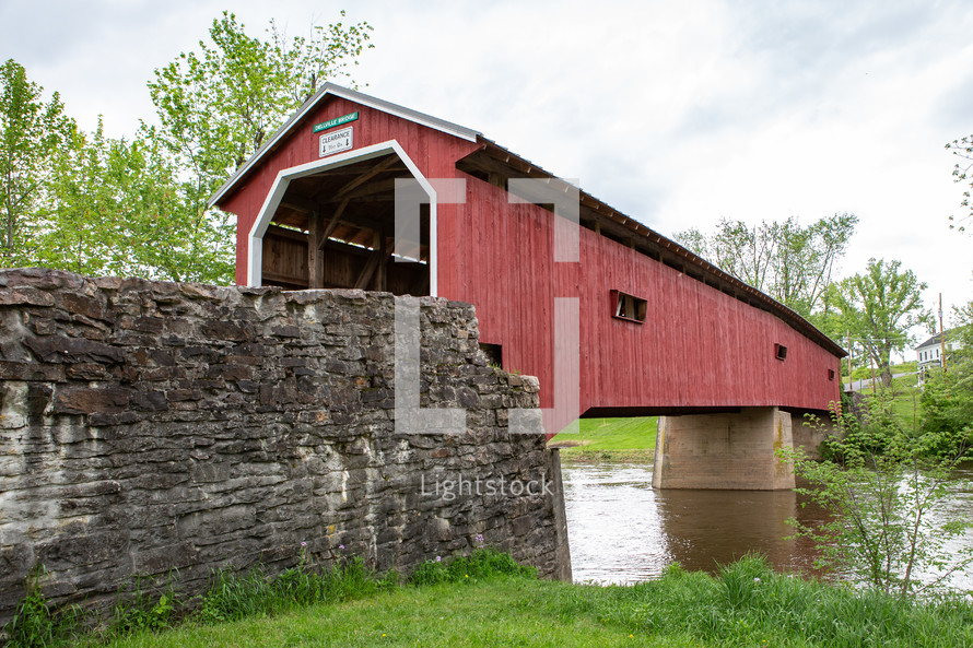 Red covered footbridge over water