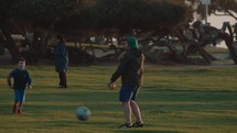 Father and Son playing football in the park