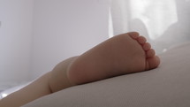 Close-up shot of little bare foot of sleeping baby.