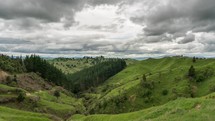 Grey clouds over green mountains nature in New Zealand landscape Time-lapse
