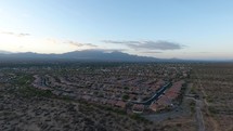 Aerial of a neighborhood with scenic mountains in the distance
