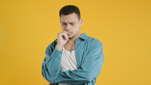 Worried thinking around hipster african american man on yellow. Confused student guy finding answer or trying to remember what he forgot, memory concept. High quality 4k