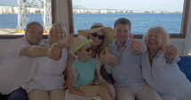 Family on board the ship showing thumbs-up
