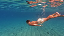 Boy swimming in the ocean