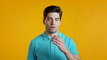 Frustrated european man over yellow wall background. Guy is tired, bored of work or studying, he disappointed, helpless