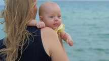 Mum with baby daughter enjoying sea and breeze