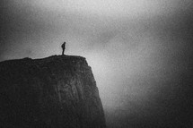 girl standing at the edge of a cliff 