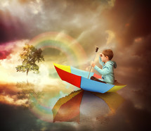 a child floating in a rainbow colored umbrella 