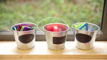 buckets in a preschool classroom window sill 