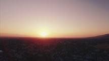 Panning Aerial view over a city at sunset | Light | Community | People | Evangelism | Pray for the City | Streets | Cars | Houses | Homes | World | Skyline | Sky | Motion 