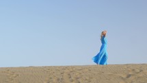 Woman walking on beach skyline