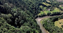 Aerial View Of The  Aries River Surrounded With Green Forest On Sunny Day In Romania.