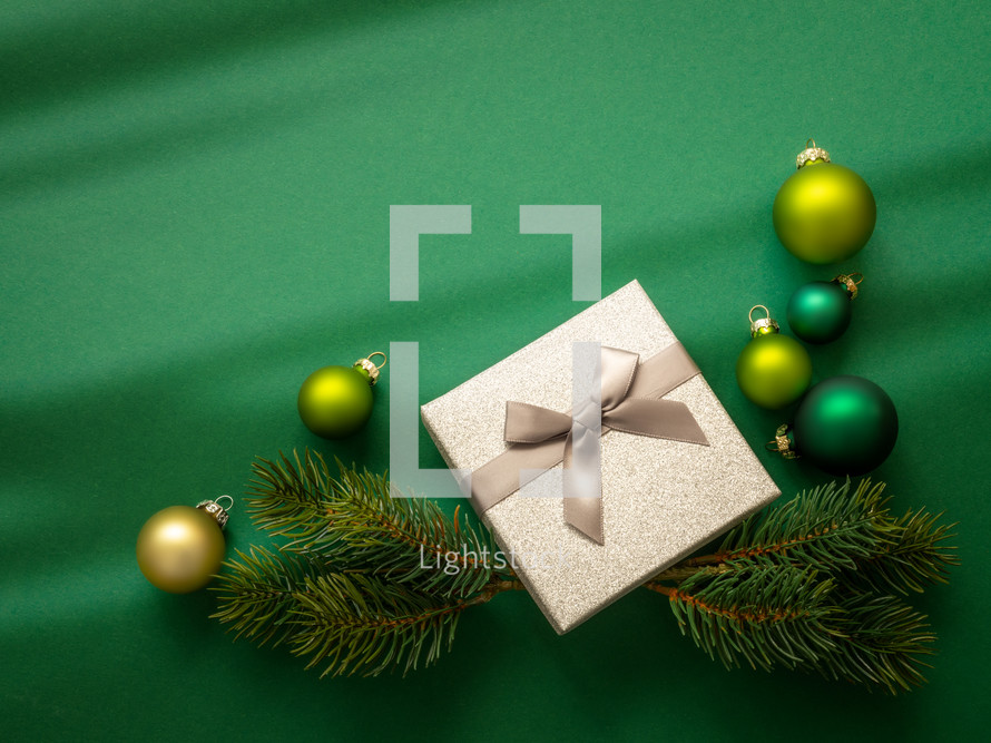 Christmas ornaments and gift on green 