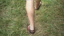 walking in sandals through grass 