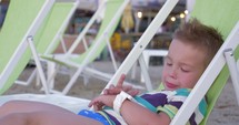 Child with smartwatch at the seaside