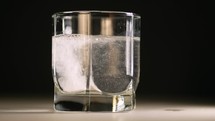 Effervescent tablet in glass of water