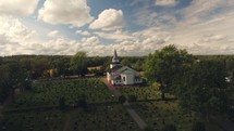 drone flight over a rural church with cemetery 