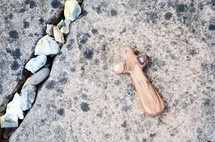 wood prayer cross on pavement 