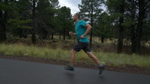 A man running on a country road in slow motion