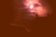 moon over a house roof 