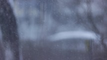 Snowfall On Wintertime At The City Against Shallow Depth Of Field. Defocus