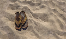 A pair of sandals in the sand