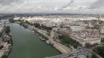 Guadalquivir river and cityscape, Seville in Spain. Aerial panoramic view