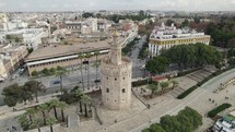 Aerial drone orbiting around Tower of Gold or Torre del Oro at Seville in Spain
