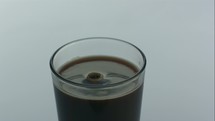 splashing cold brew in a glass 