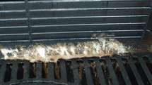 Cleaning grease from a barbecue grill using baking soda effectively removes burnt residue and restores hygiene