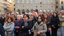 Large group of people gathered in an Italian street. 