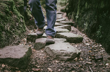 a person hiking along stepping stones
