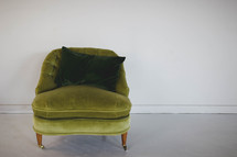 green chair and throw pillow 