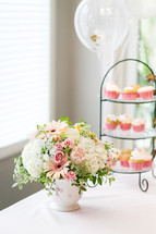 floral arrangement and cupcakes 