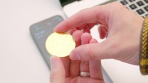 Bitcoin cryptocurrency coin in hand for investing decision 