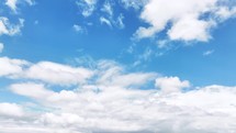 Time-lapse of moving cumulus clouds on a beautiful blue sky day in the summertime. 