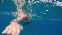 Man Swimming freestyle in the ocean during Summer time