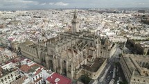 Seville Cathedral view from above in City Downtown, Aerial Pullback Panorama