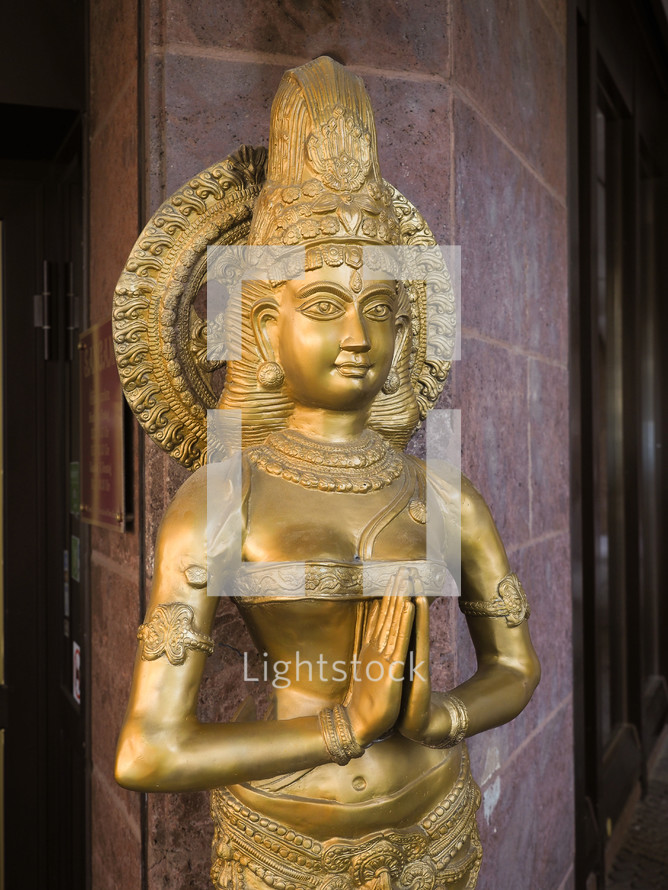 ancient golden statue of traditional indian goddess