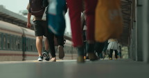 Footsteps of people walking quickly in the train station
